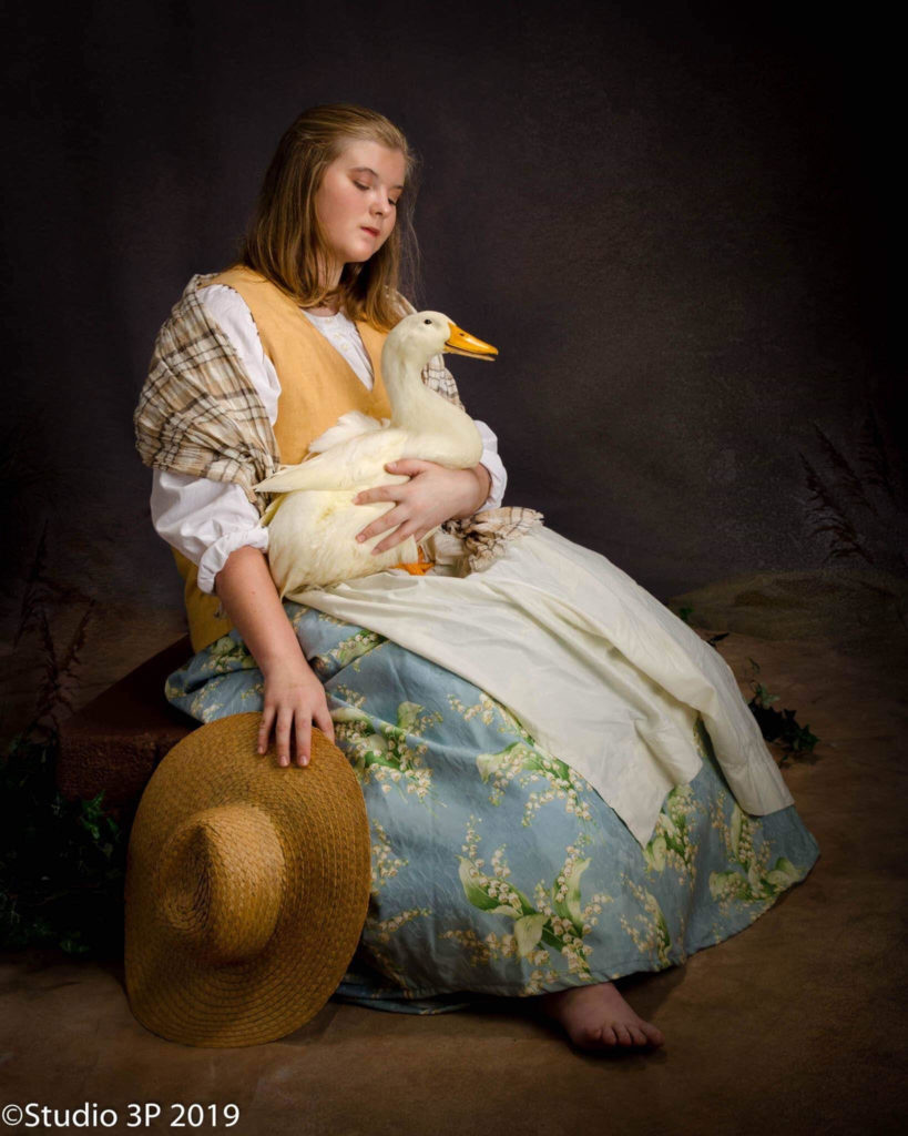 portrait of farm girl holding duck