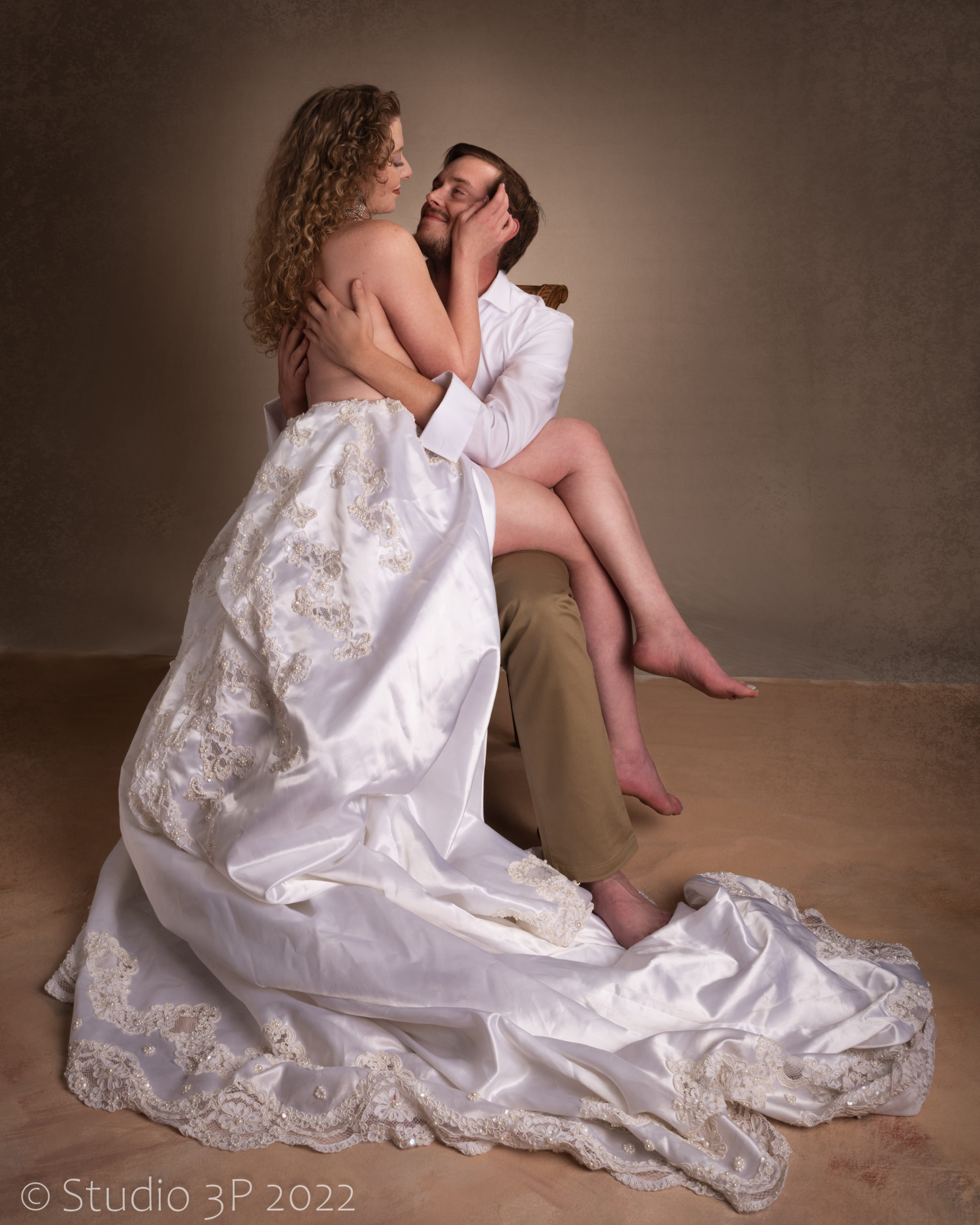 Passionate couple with white flowing gown.